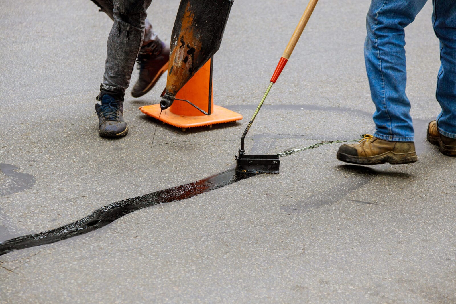 Crack sealing on asphalt pavement